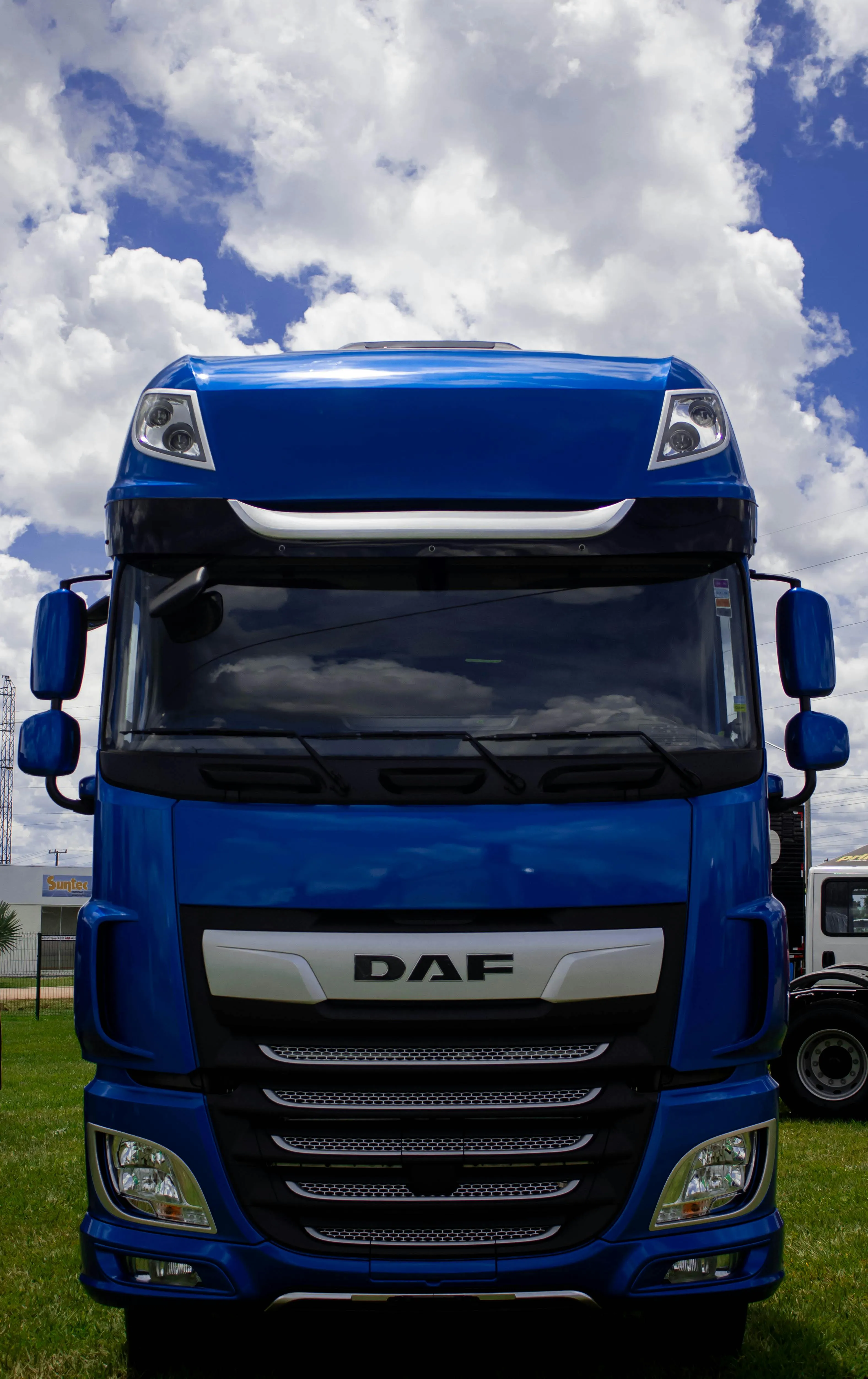 Front view of a blue DAF lorry under a cloudy sky, representing AM2PM Tyres's Lorry Tyres services in Reading.