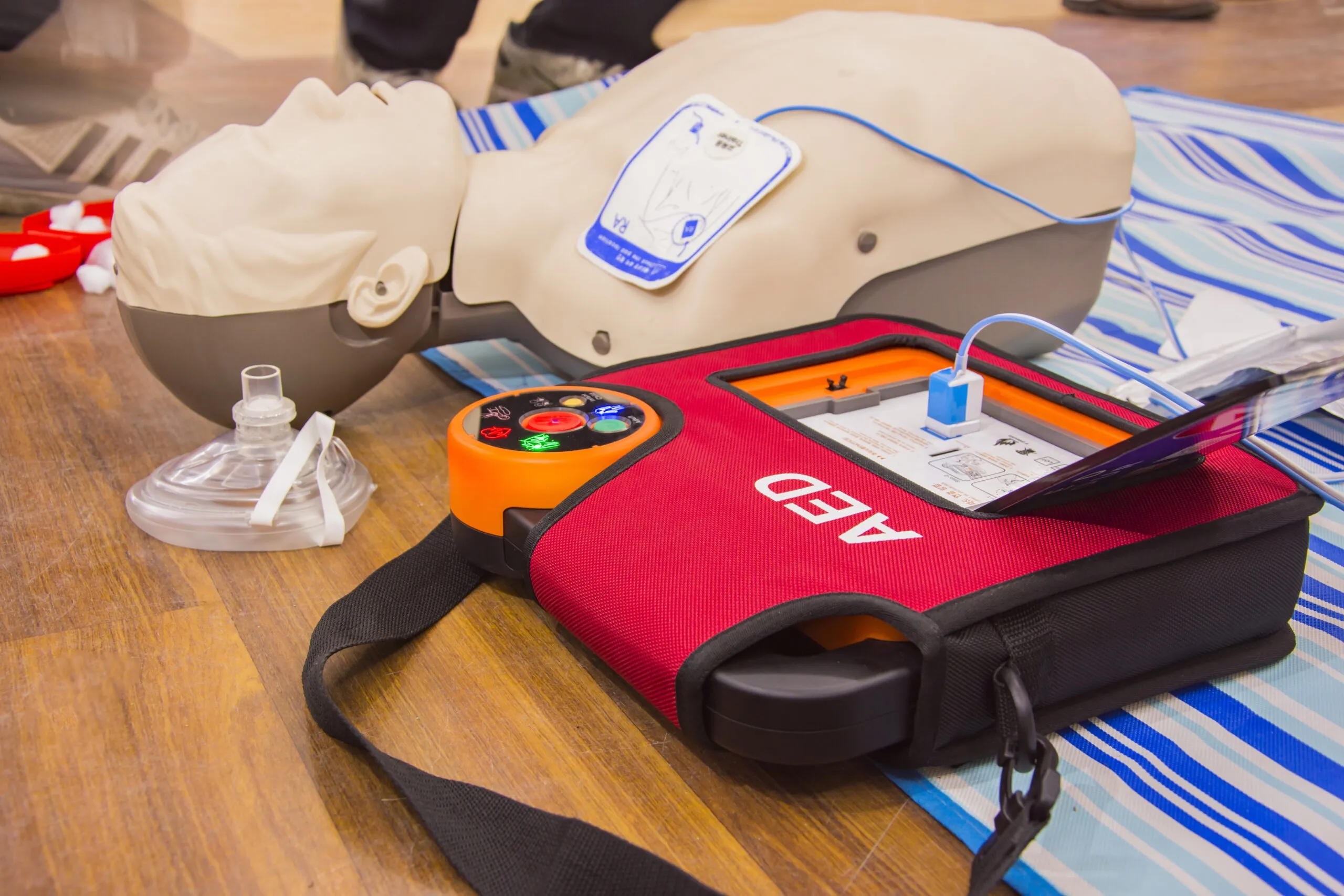 CPR training mannequin and AED equipment used in AFW Training Ltd's First Aid Training Course in Harlow.