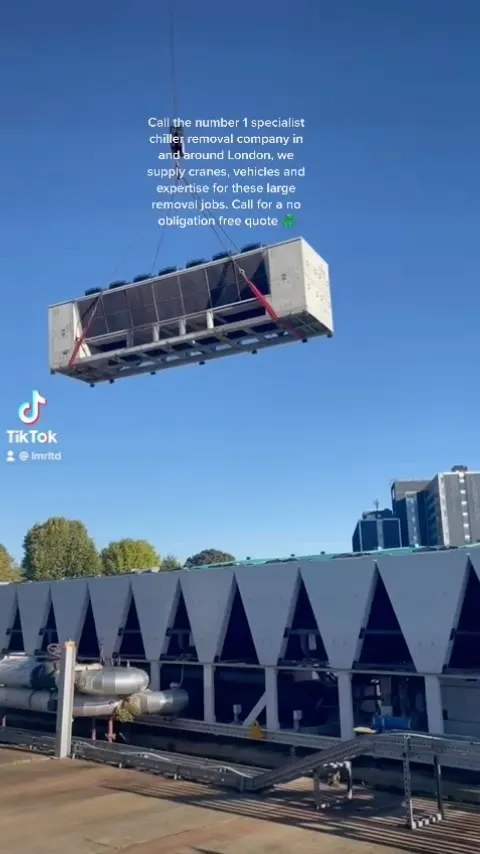 A large industrial chiller unit is being lifted by a crane, illustrating London Metal &amp; Recycling Ltd's expertise in ⁠Commercial Kitchen, Chiller &amp; Ac Unit Recycling.