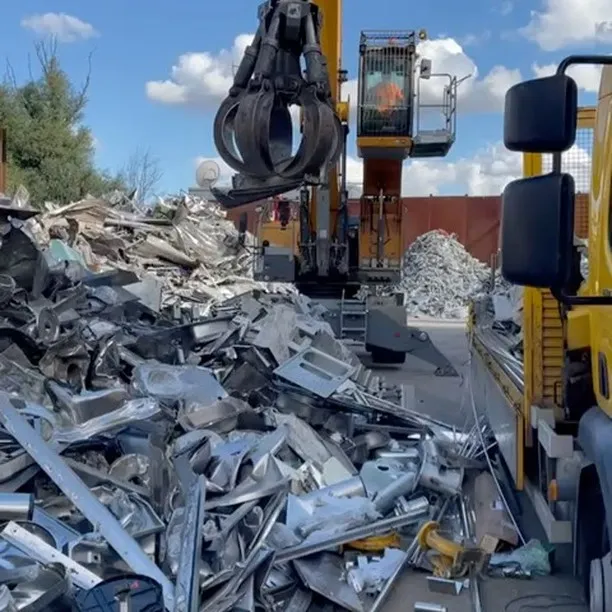 Excavator sorting scrap metal in a recycling yard, showcasing London Metal &amp; Recycling Ltd's services for Scrap Commercial Kitchen &amp; Catering Equipment Recycling in Tower Hamlets.
