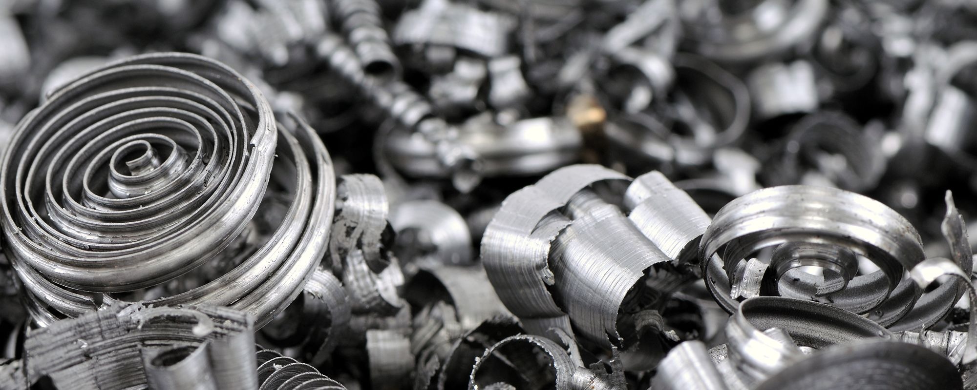 Close-up of coiled metal shavings, representing scrap metal recycling services offered by Essex Scrap Metals in Harold Wood.