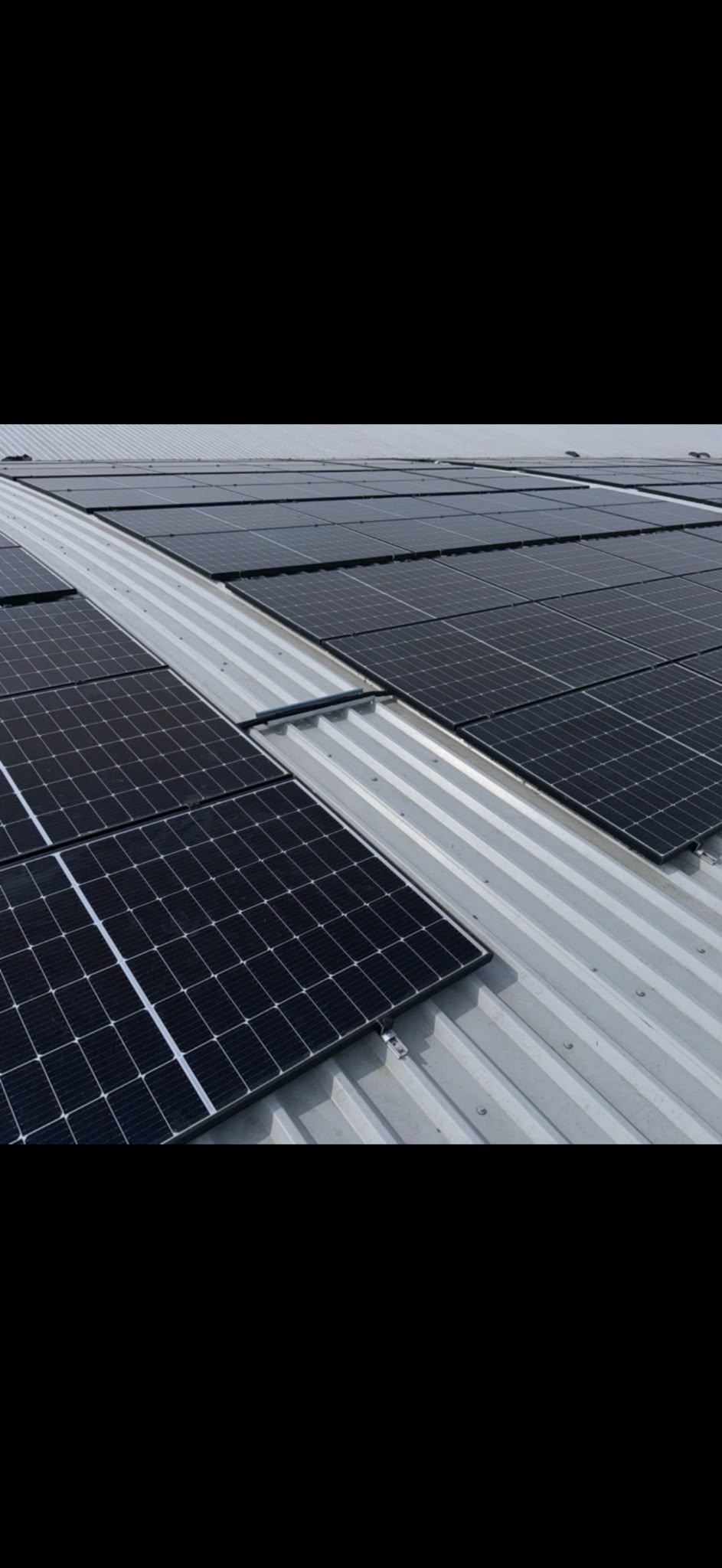Solar panels installed on a metal roof, showcasing renewable energy solutions by {{company_name}} in {{place}}.