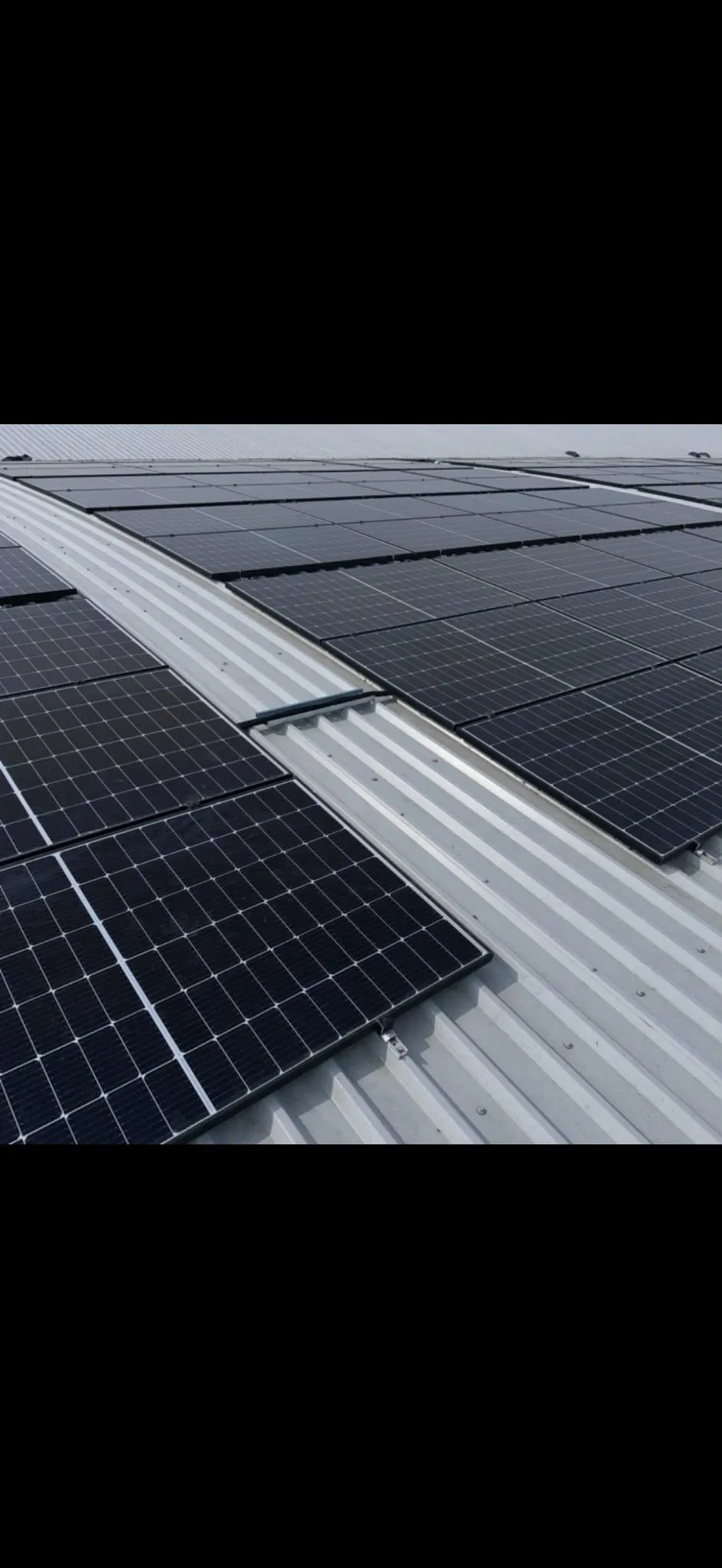 Solar panels installed on a metal roof, showcasing renewable energy solutions by ICE Electrical Solutions in Saxmundham.