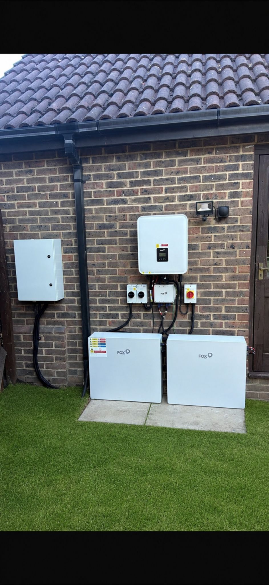 Solar panel battery storage units installed on a brick wall, showcasing {{company_name}}'s expertise in {{search_term}}.