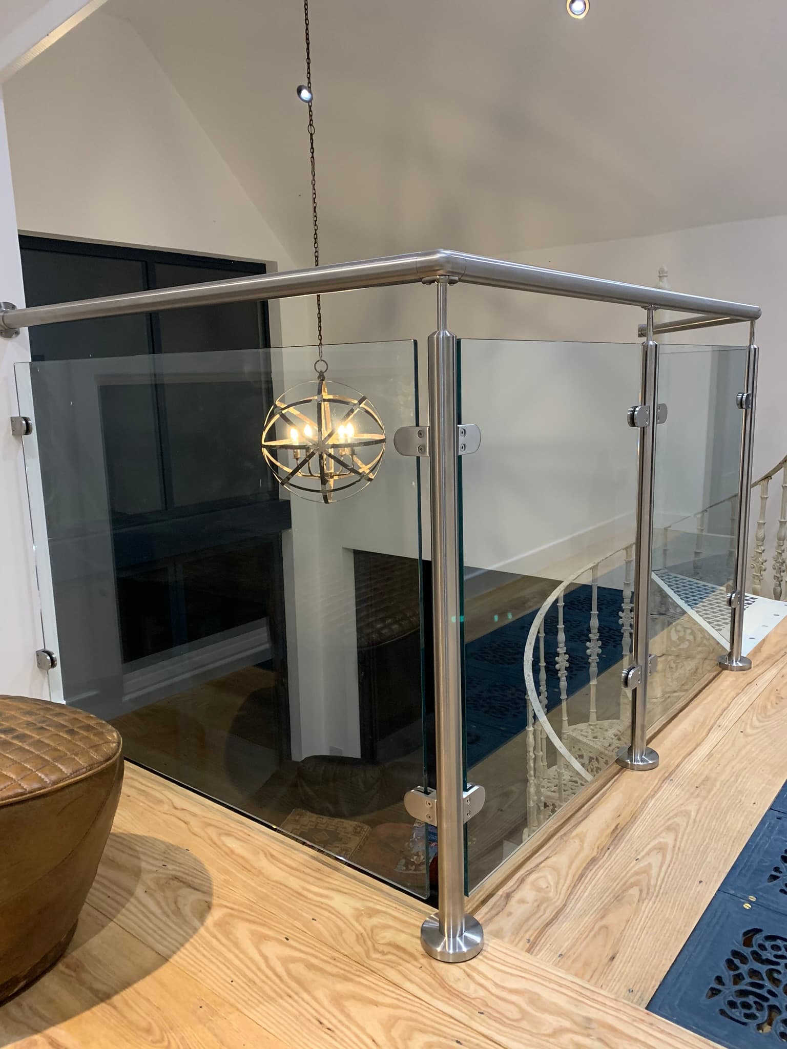 Modern glass balustrade with stainless steel posts in an interior setting, offered by FOL Design Ltd in Duxford.