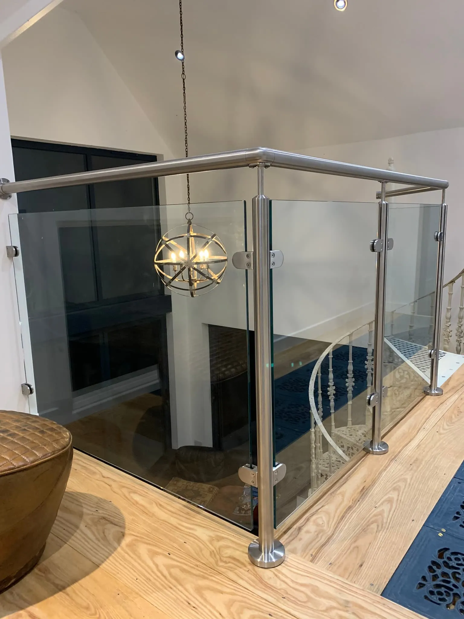 Modern glass balustrade with stainless steel posts in an interior setting, offered by FOL Design Ltd in Peterborough.