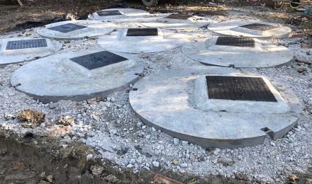 Concrete manhole covers on a construction site, illustrating groundwork services by {{company_name}} in {{place}}.