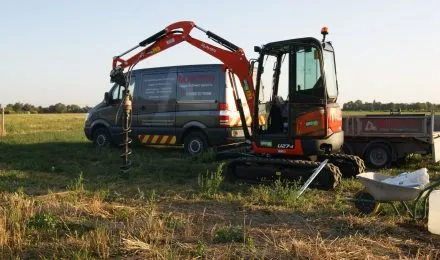 A digger and a van in a field, representing MJ Digger &amp; Driver Hire Services's Digger &amp; Driver Hire services in Haverhill.