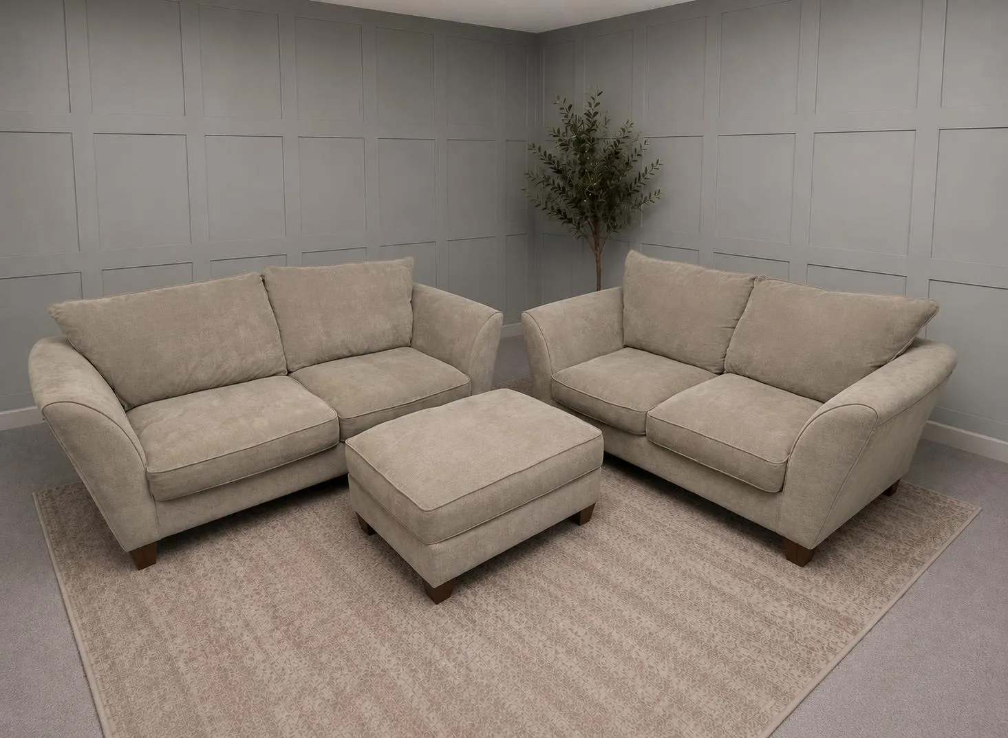 Two beige sofas and matching ottoman on a rug in a showroom, for 3 Seater Sofas For Sale by Restored Living in Bury St Edmunds