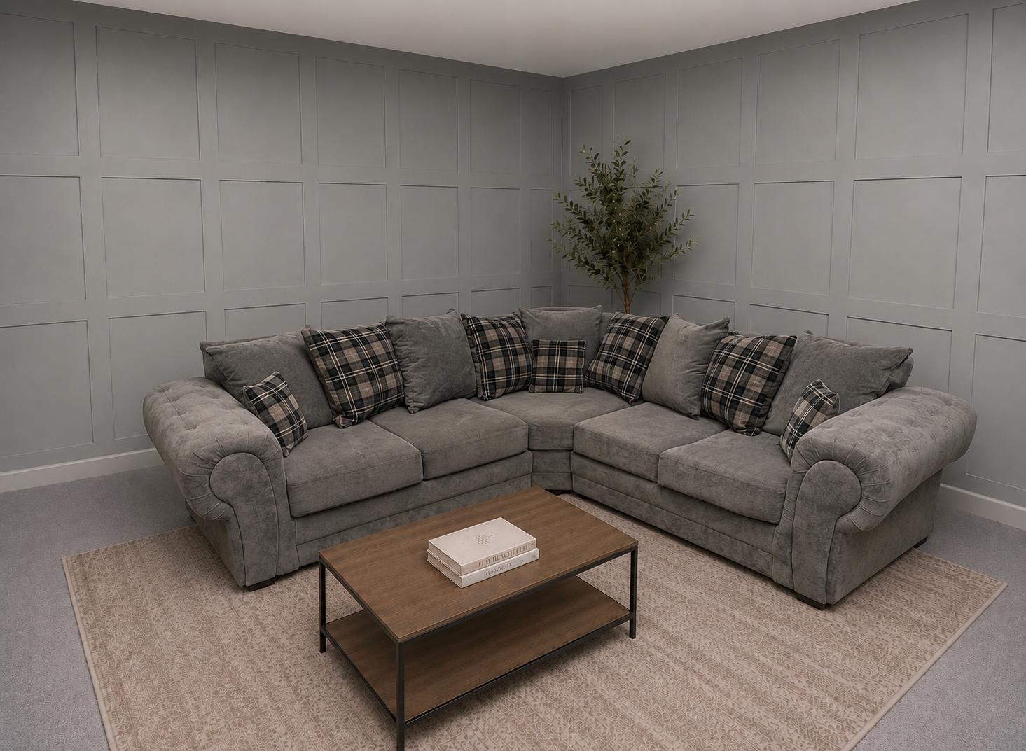 Grey corner sofa with plaid cushions in a showroom, for restored Corner Sofas For Sale at Restored Living in Clacton-on-Sea