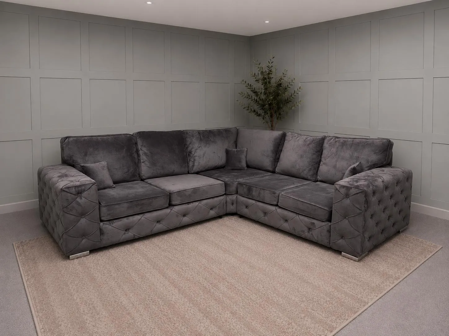 Grey velvet corner sofa in a showroom room, showing restored seating for Corner Sofas For Sale at Restored Living in Braintree