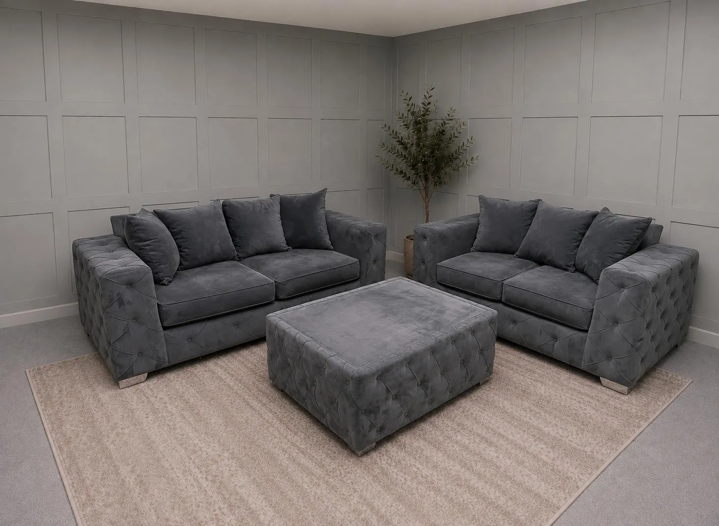 Two grey upholstered sofas with matching footstool in a showroom, for 3 Seater Sofas For Sale at Restored Living in Colchester