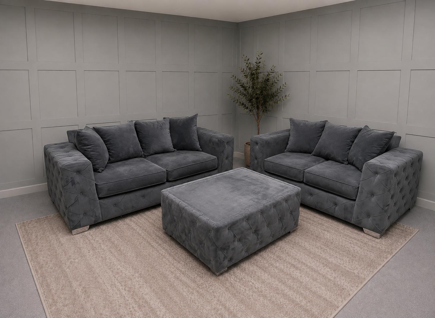 Two grey upholstered sofas with matching footstool in a showroom, for Corner Sofas For Sale at Restored Living in Clacton-on-Sea