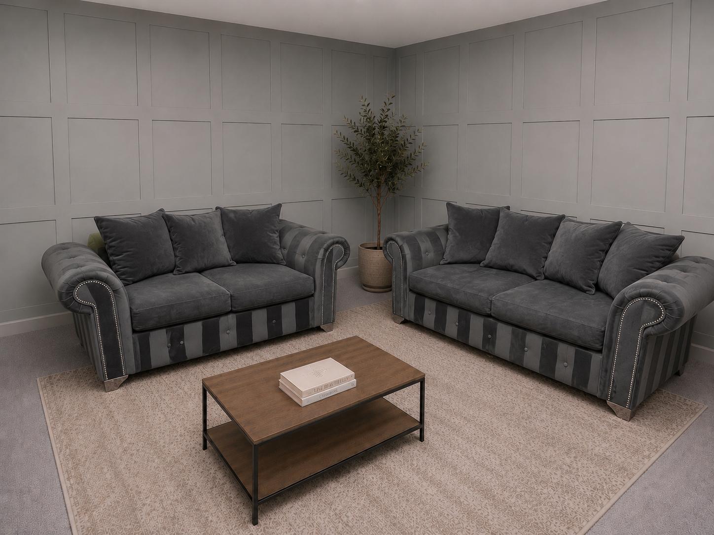Two grey sofas in a showroom, featuring a 2 seater and 3 seater, for Corner Sofas For Sale at Restored Living in Clacton-on-Sea
