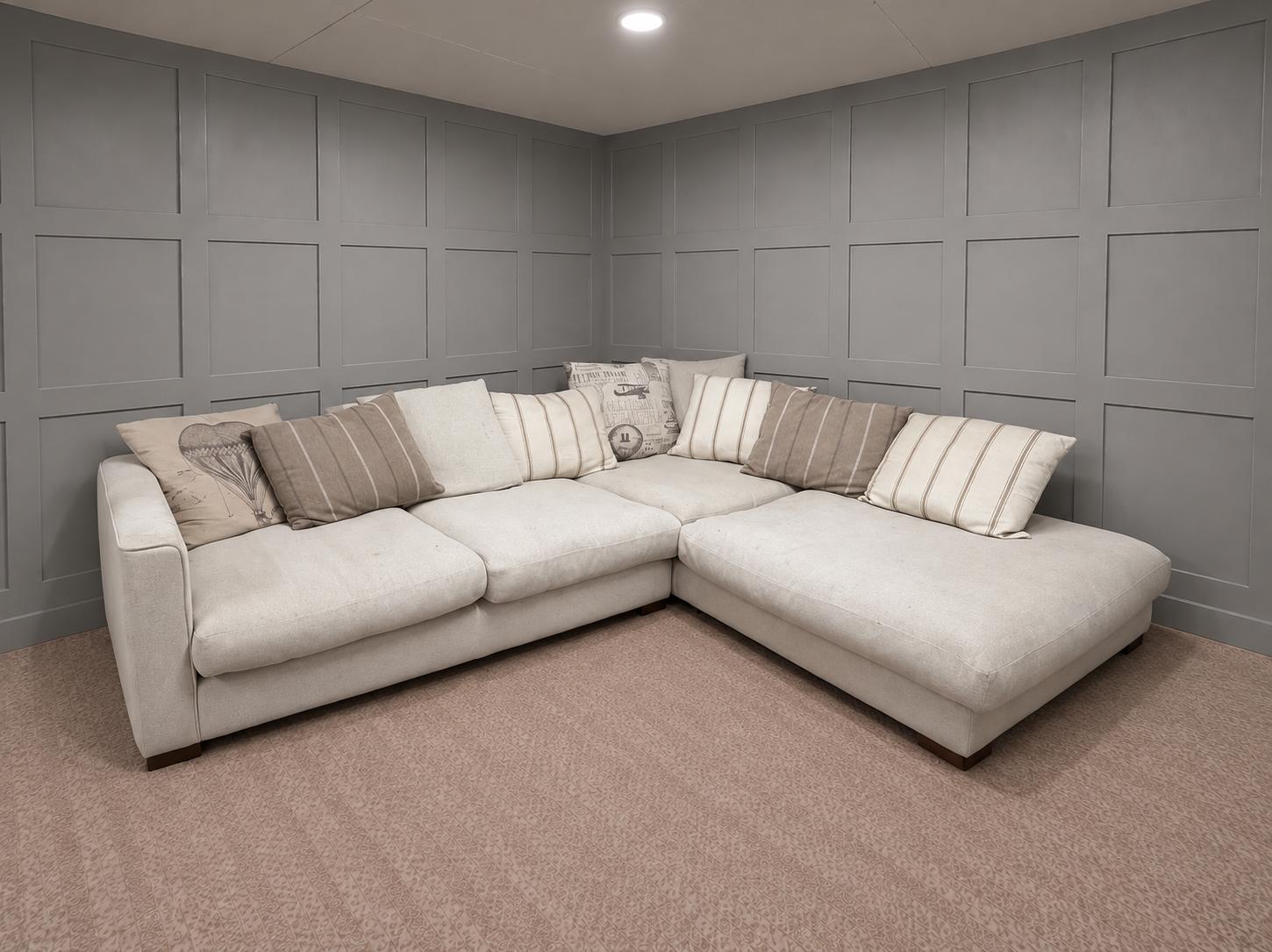 Light grey corner sofa with patterned cushions in a showroom, for Corner Sofas For Sale at Restored Living in Clacton-on-Sea