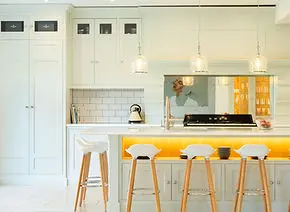Modern bespoke kitchen with white cabinetry and a central island, handcrafted by Christopher Reeve in Newmarket.
